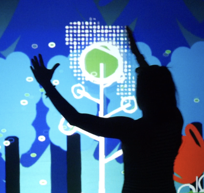 Interactive installation with silhouettes touching a digital tree